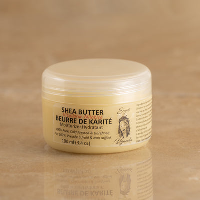 100ml Jar of Nilotica Shea Butter on a Brown Background